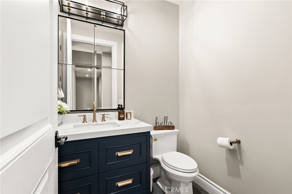 1688 Dwight Street Redlands, CA 92373 - Photo 32 of 72 a bathroom with a sink a toilet and a mirror
