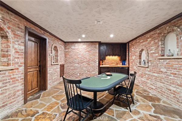 a view of a hallway with wooden floor and cabinet
