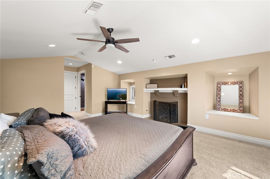 1688 Dwight Street Redlands, CA 92373 - Photo 40 of 72 a spacious bedroom with a bed and a fireplace
