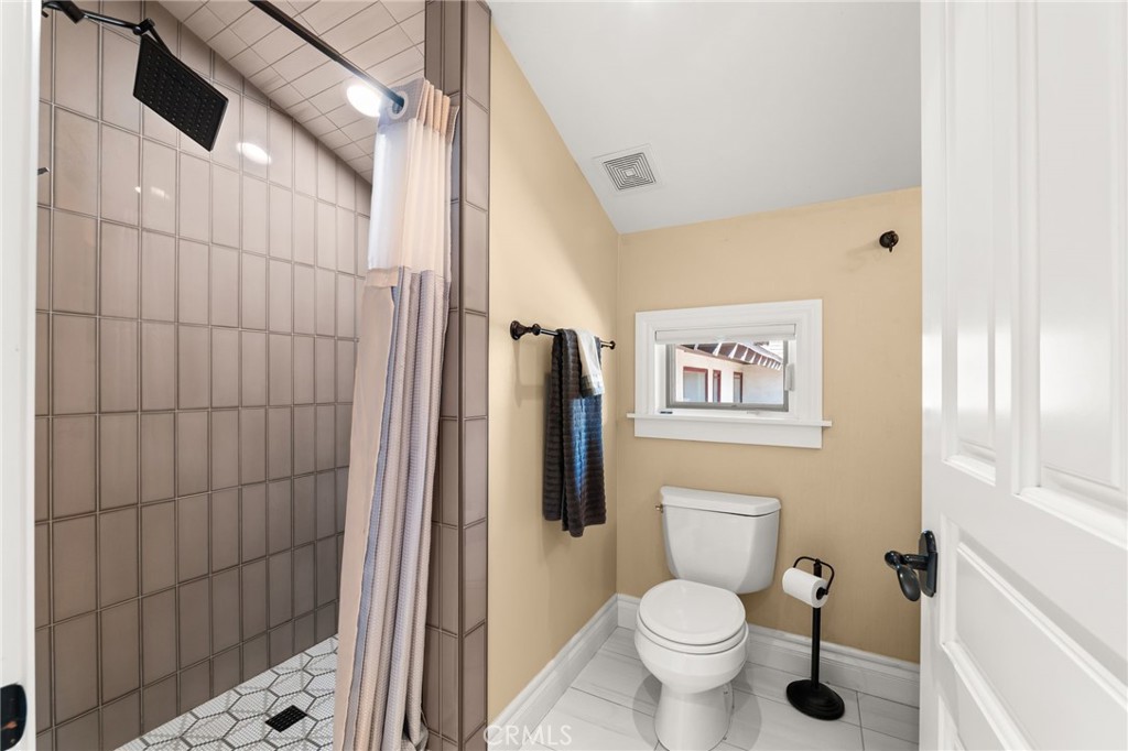1688 Dwight Street Redlands, CA 92373 - Photo 44 of 72 a bathroom with a toilet and a shower