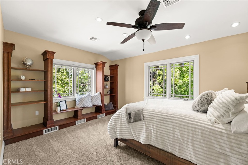 1688 Dwight Street Redlands, CA 92373 - Photo 47 of 72 a bedroom with a large bed and a chandelier