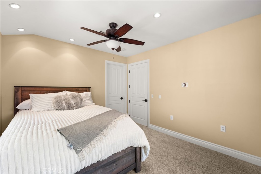 1688 Dwight Street Redlands, CA 92373 - Photo 48 of 72 a bedroom with a large bed and a chandelier