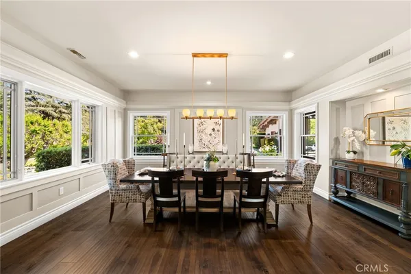 a living room with fireplace furniture wooden floor and a large window