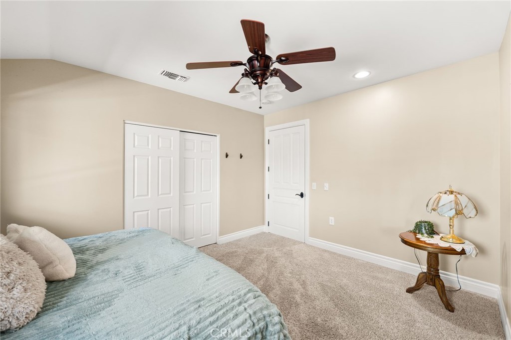 1688 Dwight Street Redlands, CA 92373 - Photo 51 of 72 a bedroom with a bed and a chandelier