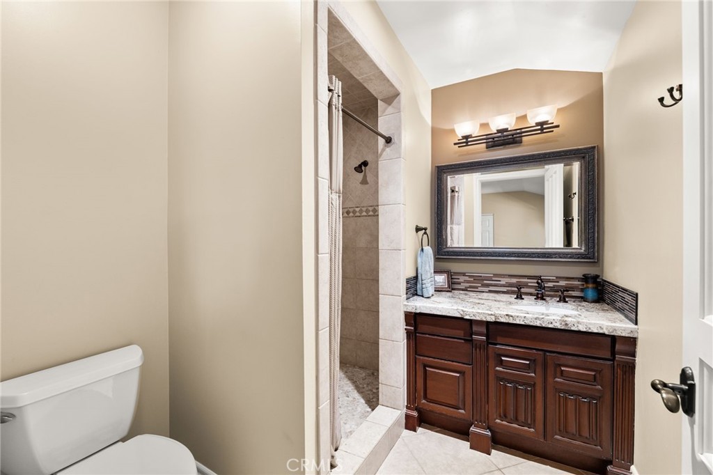 1688 Dwight Street Redlands, CA 92373 - Photo 52 of 72 a bathroom with a toilet sink and mirror