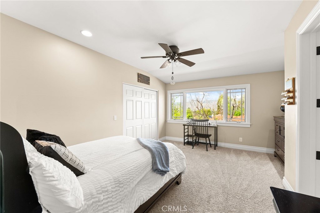 1688 Dwight Street Redlands, CA 92373 - Photo 53 of 72 a bedroom with a bed and a chair