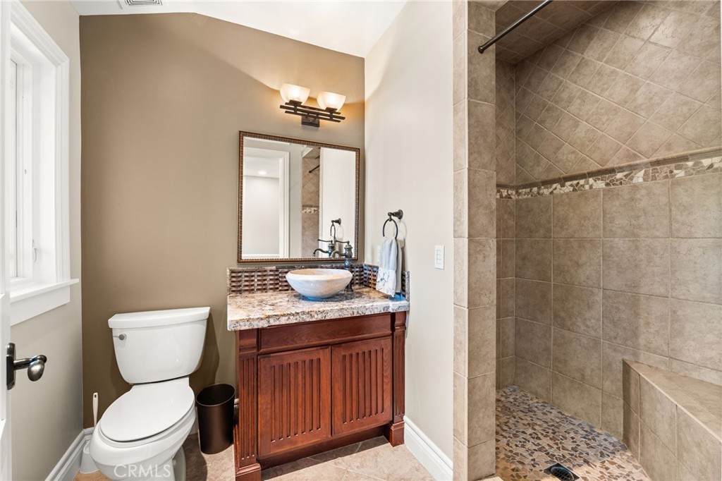 1688 Dwight Street Redlands, CA 92373 - Photo 55 of 72 a bathroom with a granite countertop sink toilet and shower