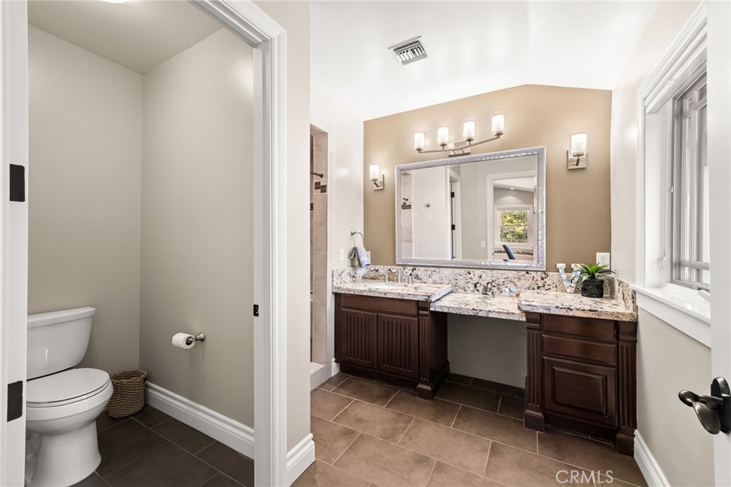 1688 Dwight Street Redlands, CA 92373 - Photo 59 of 72 a bathroom with a double vanity sink mirror and toilet