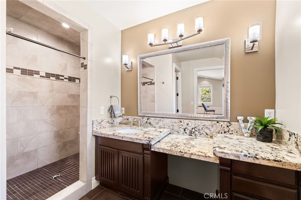 1688 Dwight Street Redlands, CA 92373 - Photo 60 of 72 a bathroom with a granite countertop sink and a mirror