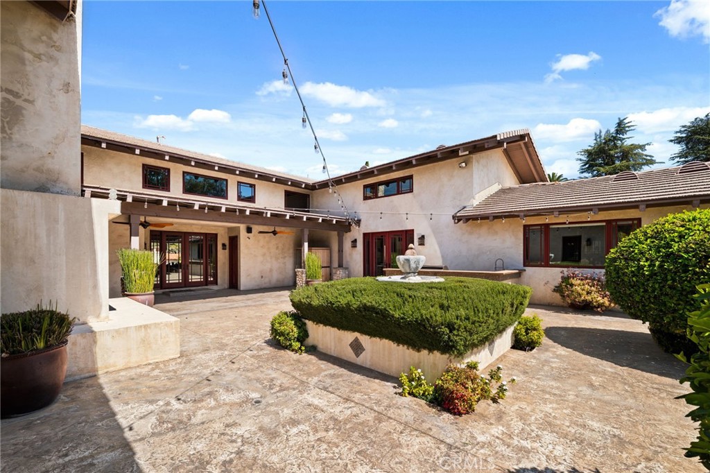 1688 Dwight Street Redlands, CA 92373 - Photo 69 of 72 a front view of a house with a yard and potted plants