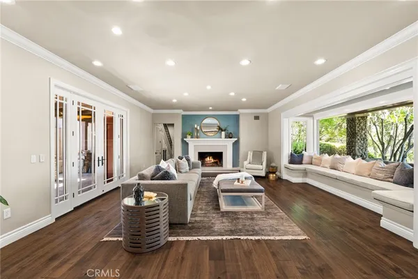 a view of a hallway with wooden floor and entryway