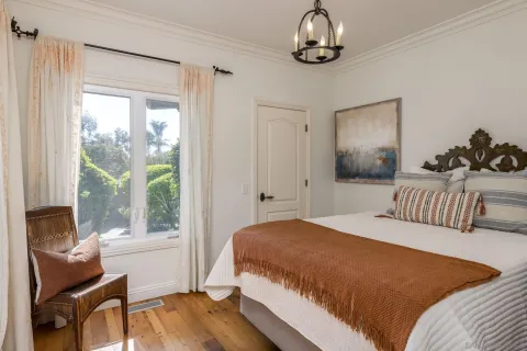 a bedroom with a large bed and a window