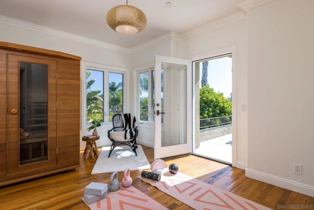 a living room with furniture rug and floor to ceiling window