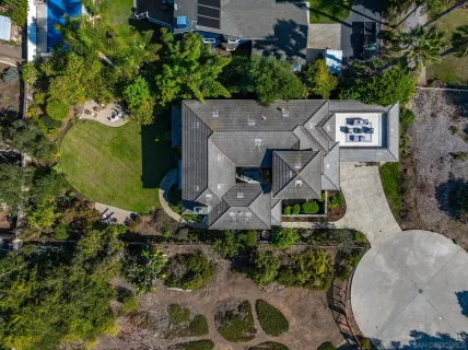 an aerial view of a house with a yard and lake view