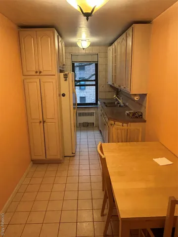 a bathroom with a sink and mirror with bathtub