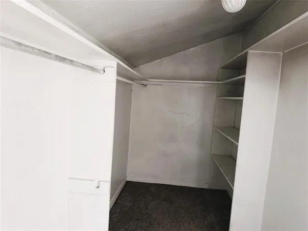 a view of walk in closet with wooden floor