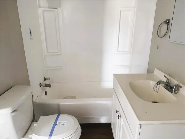 a bathroom with a sink a toilet and bathtub