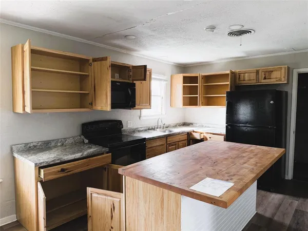 a kitchen with a stove a sink and a refrigerator