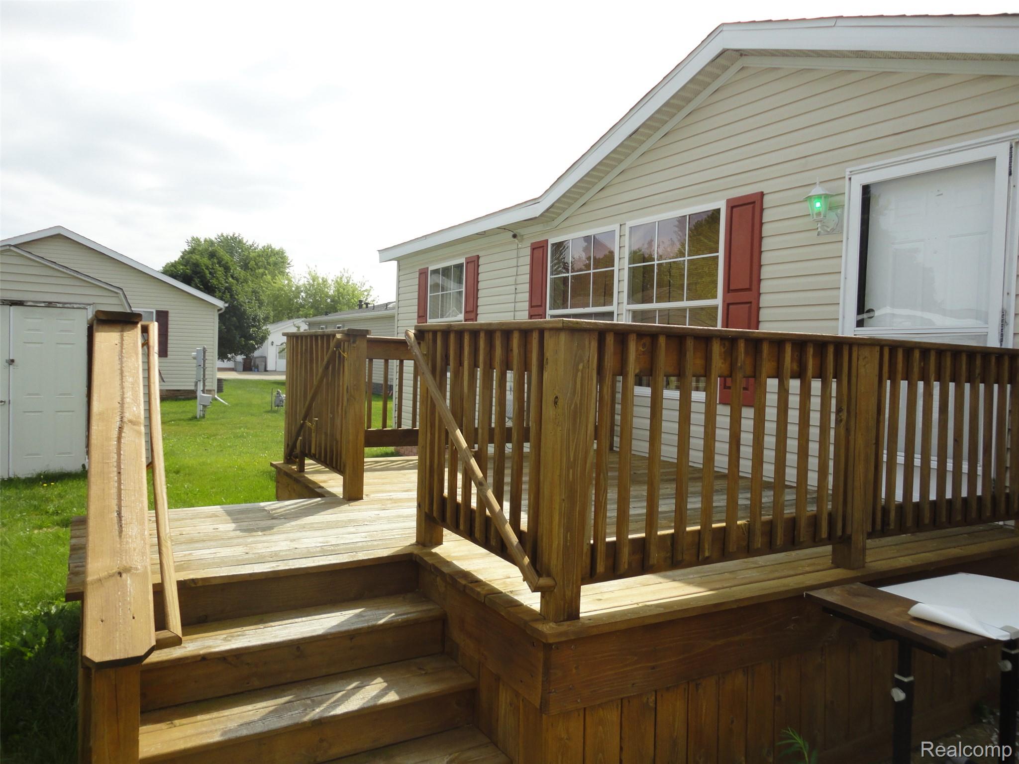3954 Ryans Ridge Monroe, MI 48161 - Photo 25 of 28 Expansive wood deck with stairs and railings