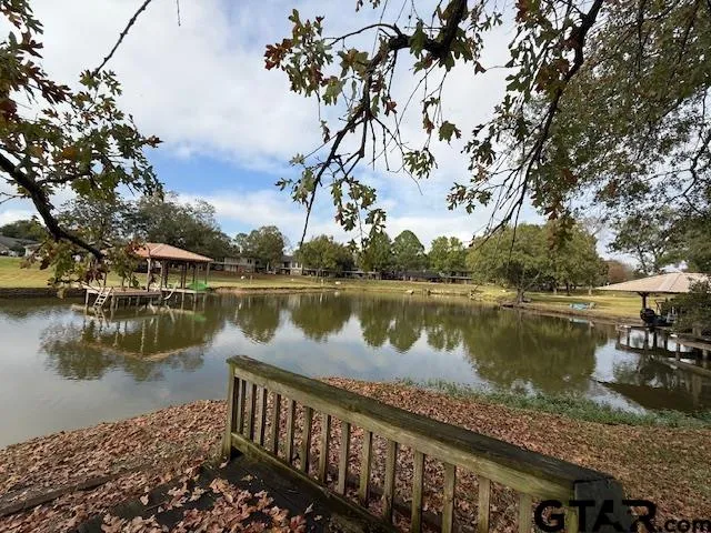 a view of a lake with a table and chairs