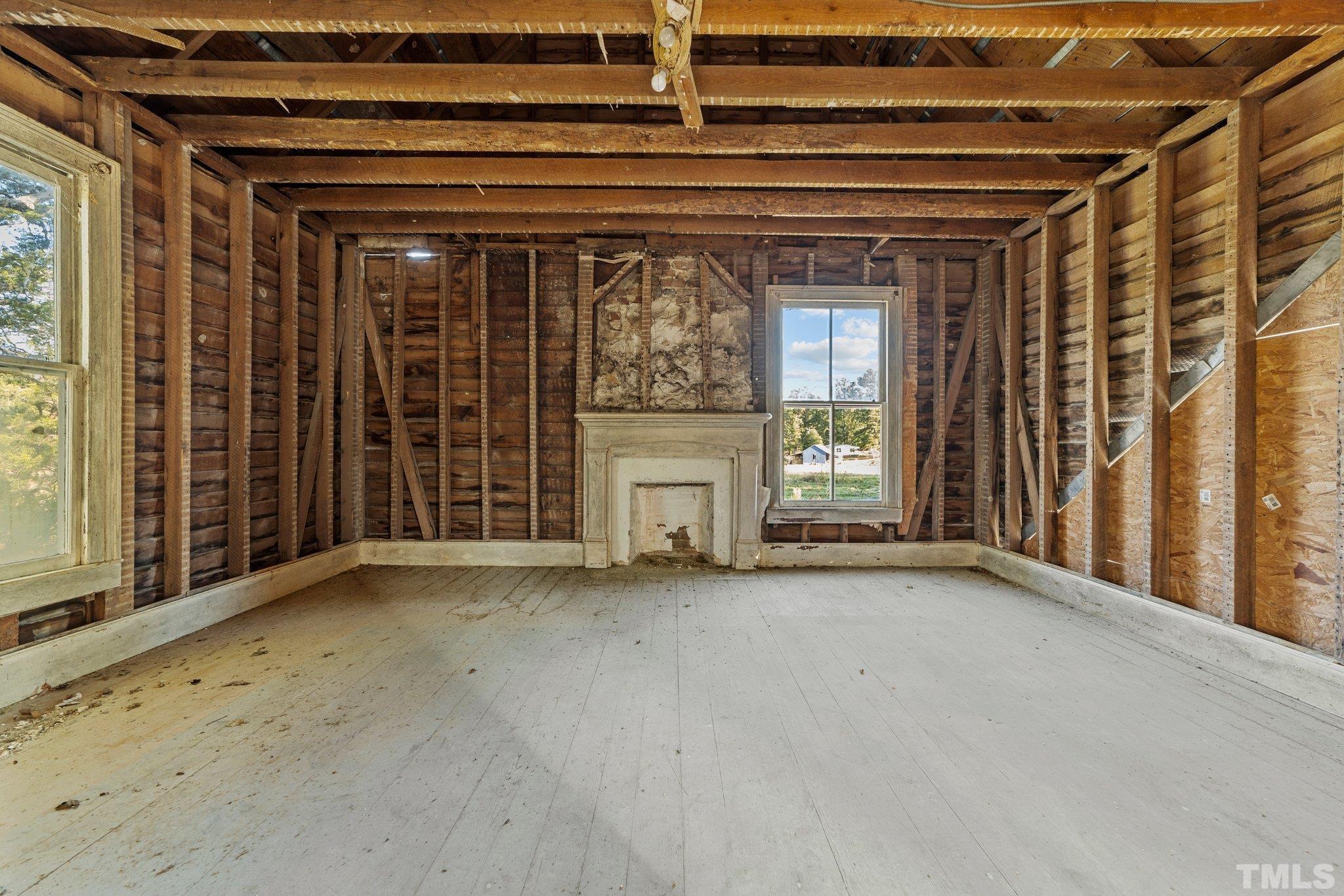 4720 Bahama Road Rougemont, NC 27572 - Photo 9 of 30 an empty room with a fireplace and windows
