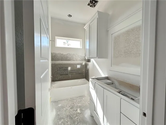 a kitchen with white cabinets and a stove