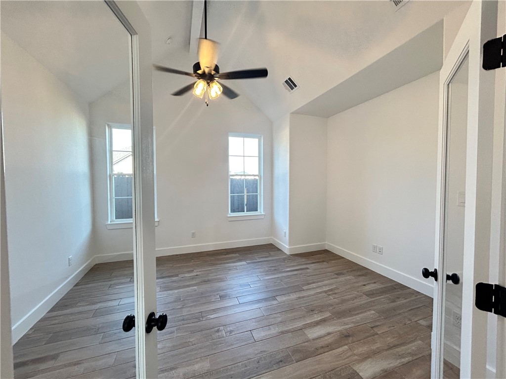 4015 Pacific Crest Way Bryan, TX 77802 - Photo 12 of 22 wooden floor in an empty room with a window