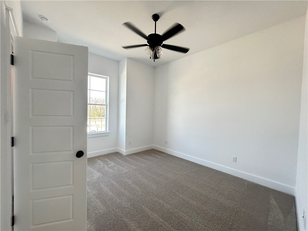 4015 Pacific Crest Way Bryan, TX 77802 - Photo 14 of 22 an empty room with windows and ceiling fan