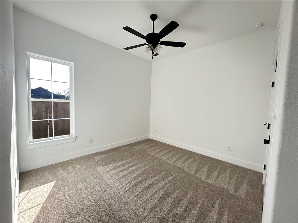 4015 Pacific Crest Way Bryan, TX 77802 - Photo 16 of 22 an empty room with ceiling fan and window