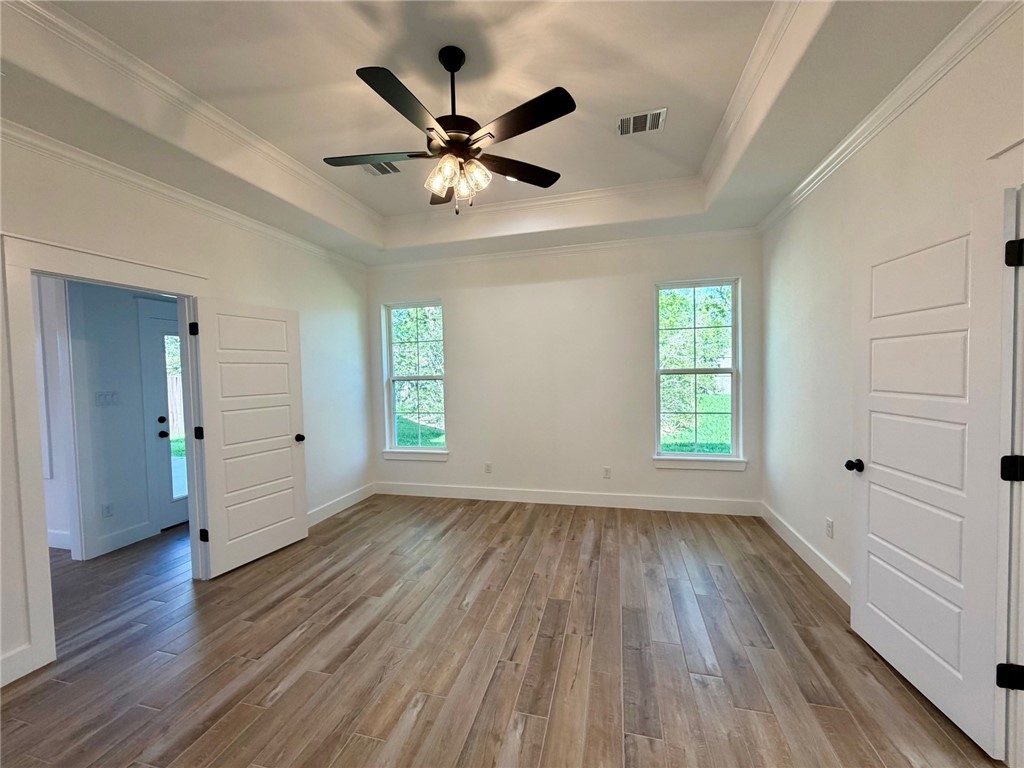 4015 Pacific Crest Way Bryan, TX 77802 - Photo 6 of 22 wooden floor in an empty room with a window