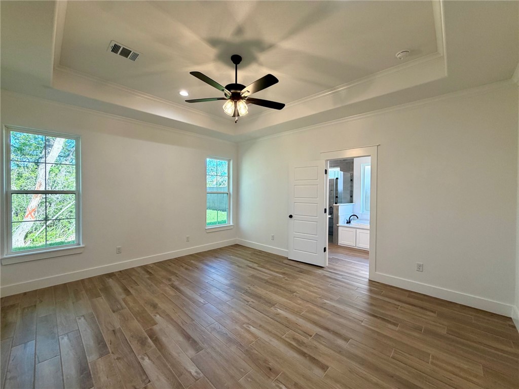 4015 Pacific Crest Way Bryan, TX 77802 - Photo 7 of 22 a view of empty room with wooden floor and fan