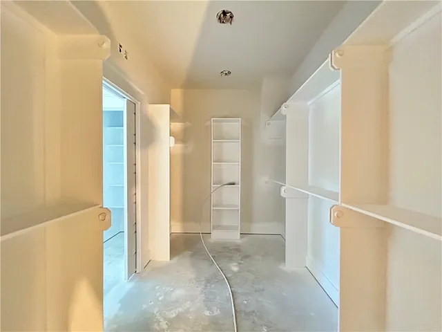 a bathroom with a shower and closet