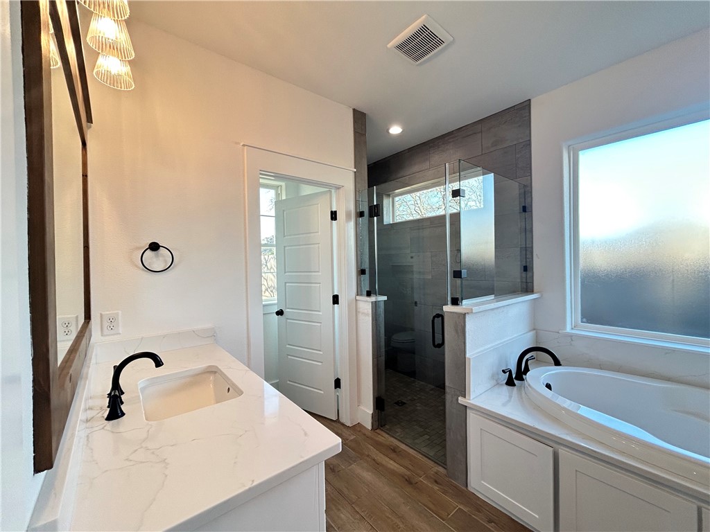 4015 Pacific Crest Way Bryan, TX 77802 - Photo 8 of 22 a bathroom with a tub sink and mirror