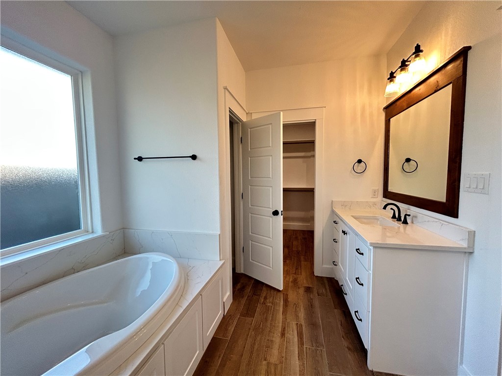 4015 Pacific Crest Way Bryan, TX 77802 - Photo 9 of 22 a bathroom with a tub sink and mirror