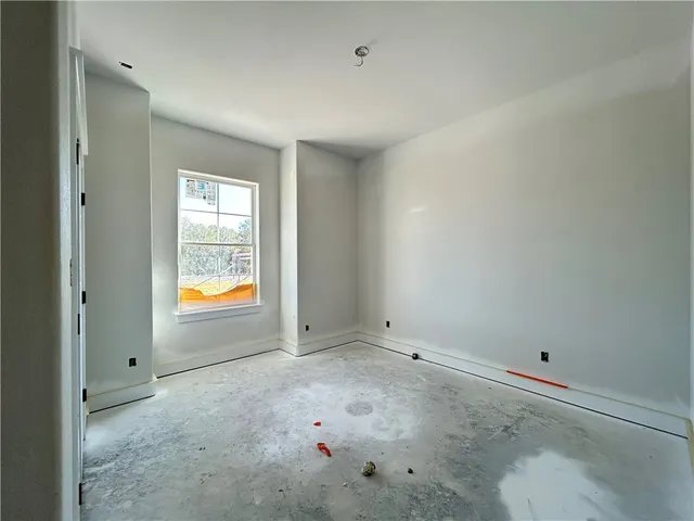 an empty room with wooden floor and a window