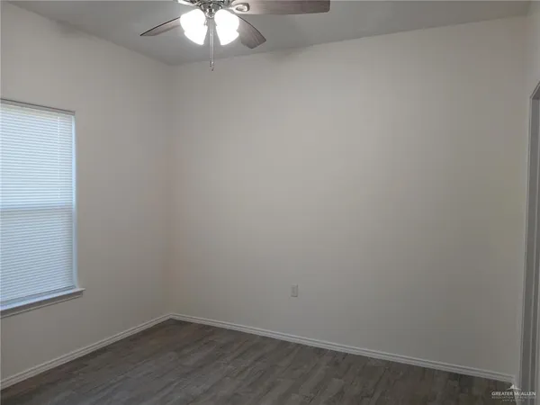 a view of a small space with wooden floor and a window