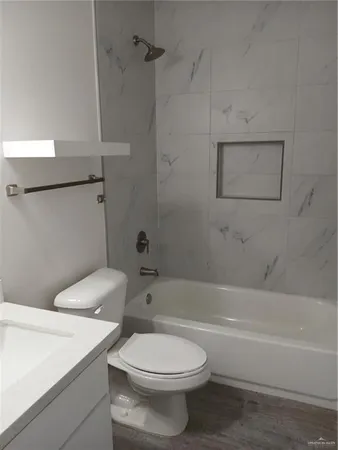 a bathroom with a sink a toilet and a bathtub