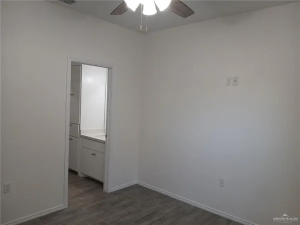 an empty room with wooden floor and closet