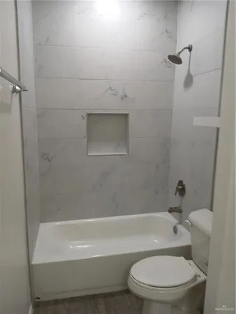 a bathroom with a toilet and a bath tub