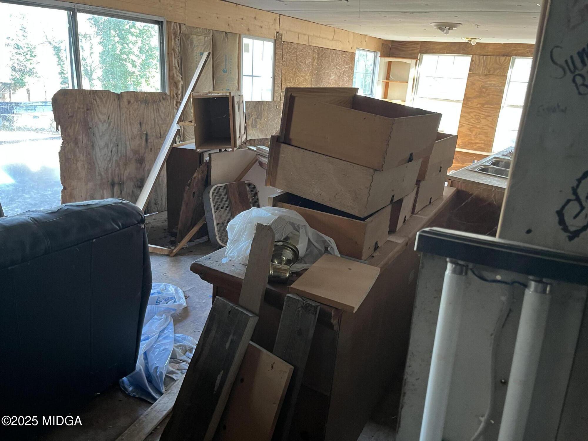 65 Little John Trail Hampton, GA 30228 - Photo 9 of 10 a living room with furniture and a window