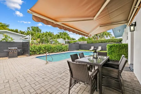 a view of a patio with table and chairs and potted plants