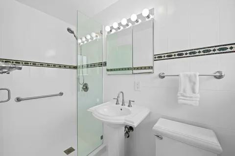 a bathroom with a sink a mirror and a shower