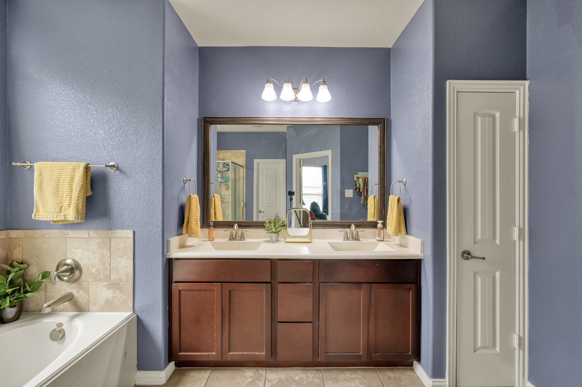 3562 Hamilton Bend Lane Spring, TX 77386 - Photo 11 of 17 The primary bathroom features a double-sink vanity, a soaking tub, and a separate shower, giving you a functional space to start and end the day.