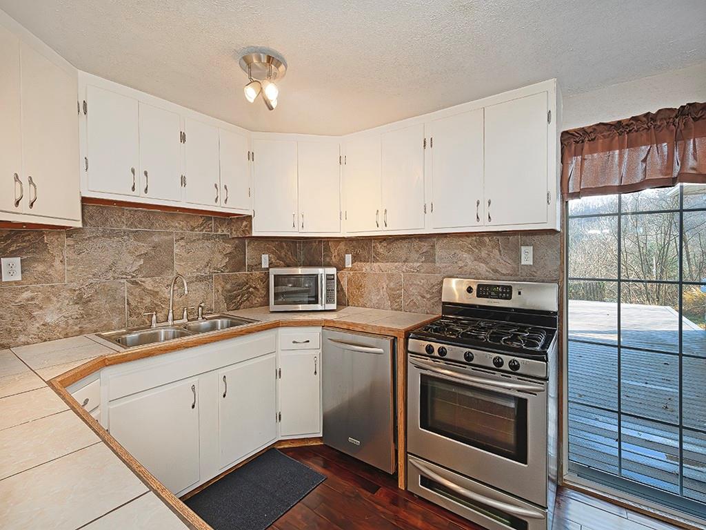 223-227 Old Mill Road Apollo, PA 15613 - Photo 15 of 45 a kitchen with cabinets appliances and a sink