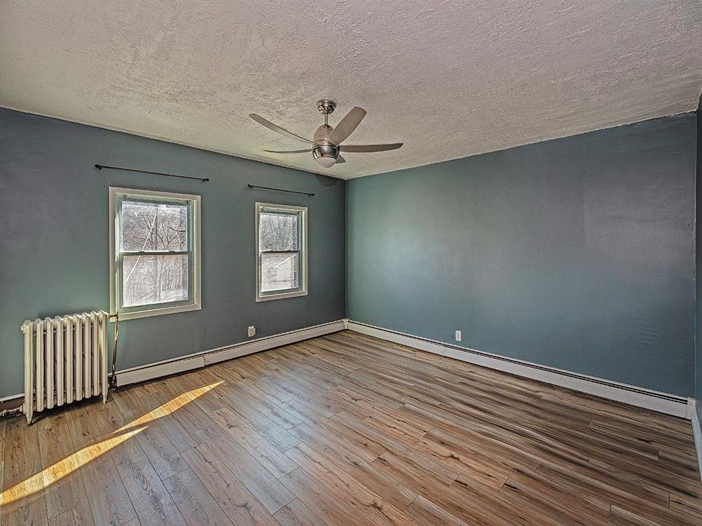 223-227 Old Mill Road Apollo, PA 15613 - Photo 23 of 45 an empty room with wooden floor chandelier fan and windows