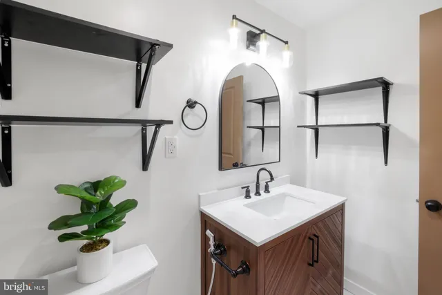 a bathroom with a sink a mirror and a shower