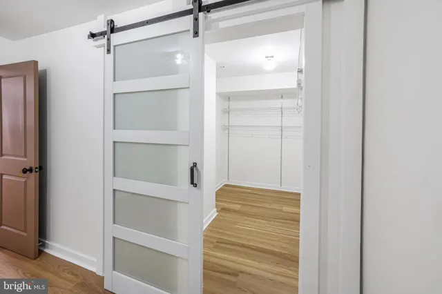a view of walk in closet with empty racks