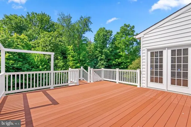 a balcony with wooden floor and fence
