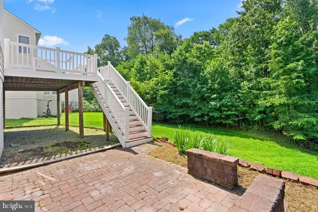 a view of a house with backyard and a sitting area