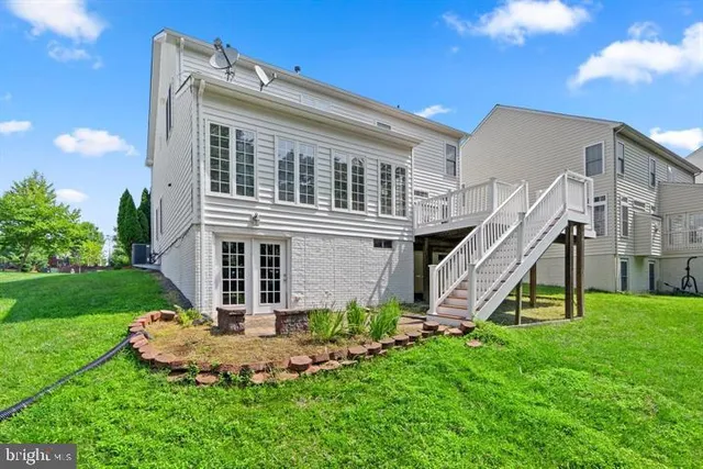 a view of a house with a yard and a slide
